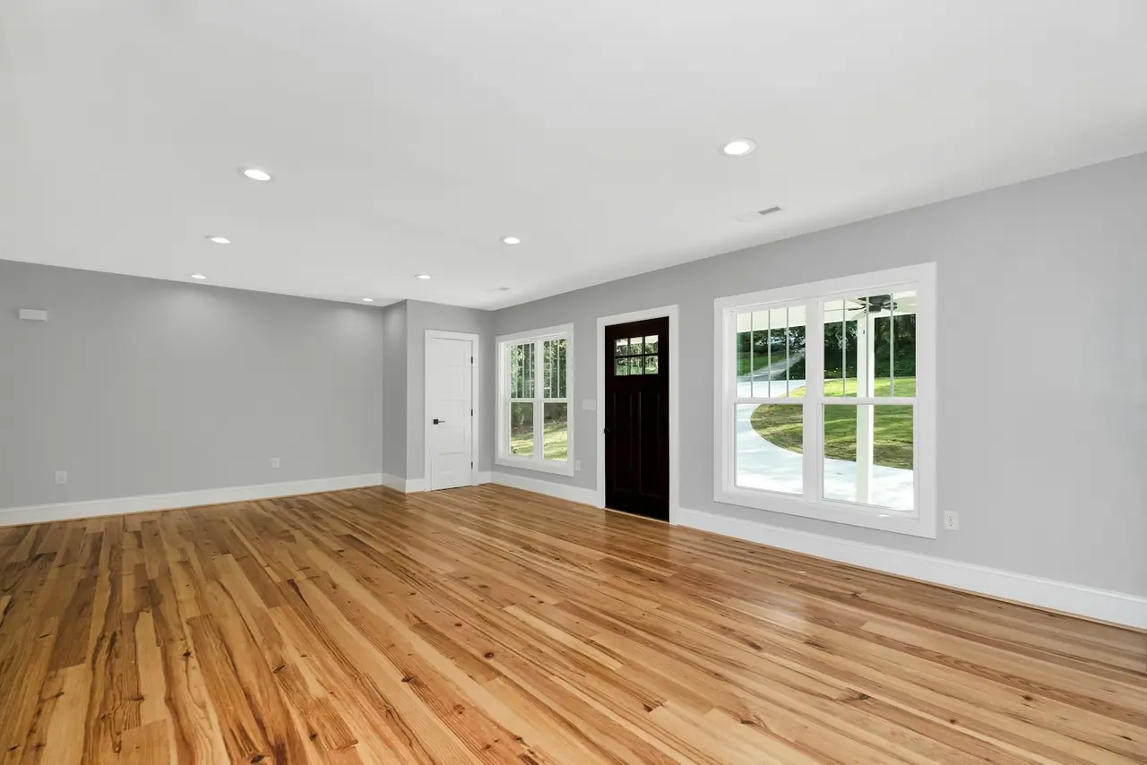 An empty room with new hardwood floors