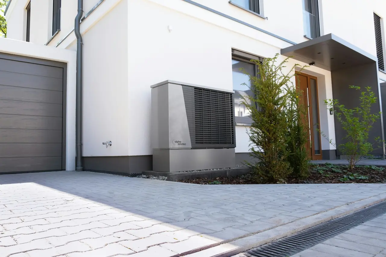 A heat pump beside a modern house